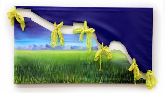 a green landscape partially covered by a dark-blue drape adorned with yellow ribbons.