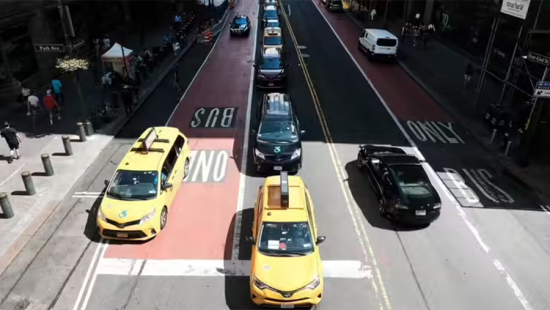 Aerial view of New York City street with cars and taxi traffic