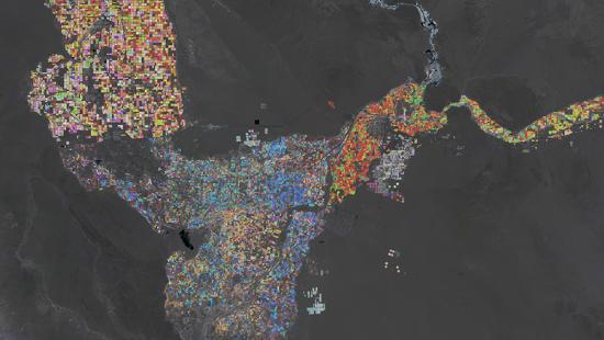 colorful blocks filling plats of land on a map with a black background