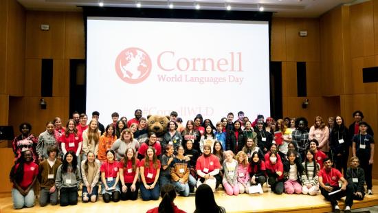 People on a stage in front of a projection screen 