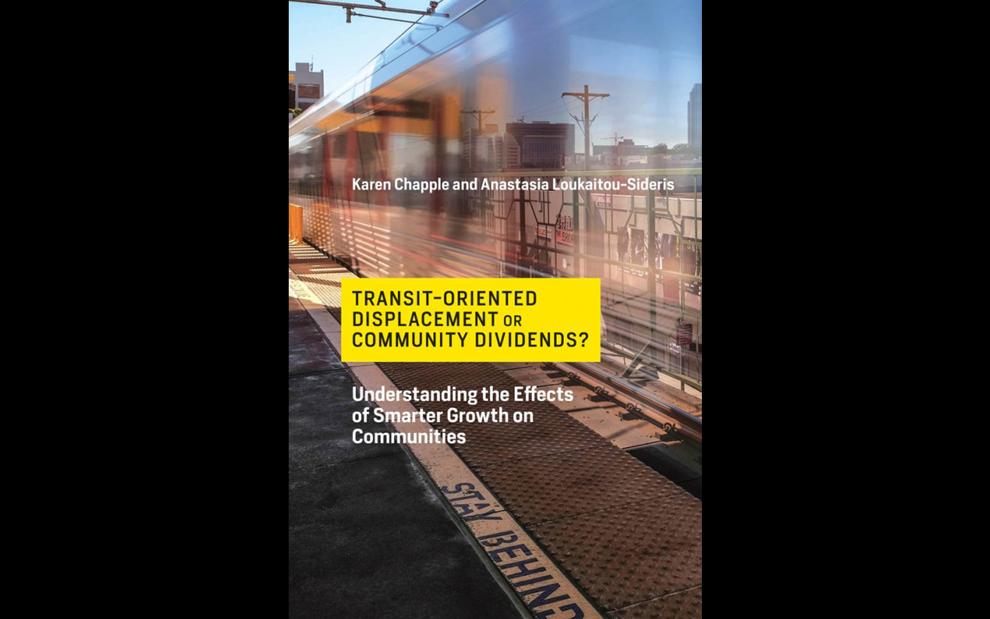 A translucent train passing through a station with a yellow rectangle and black text on the front.