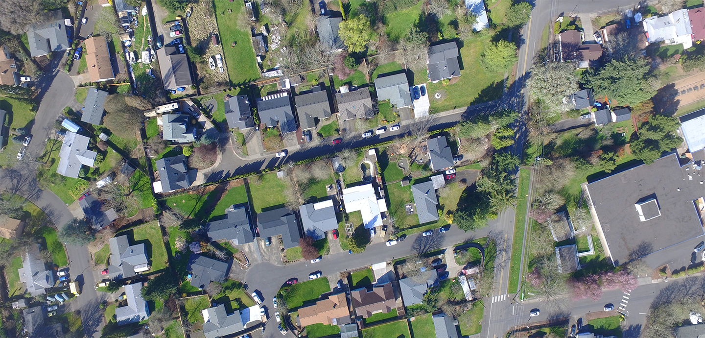 Birds eye view of various houses arranged in a community.