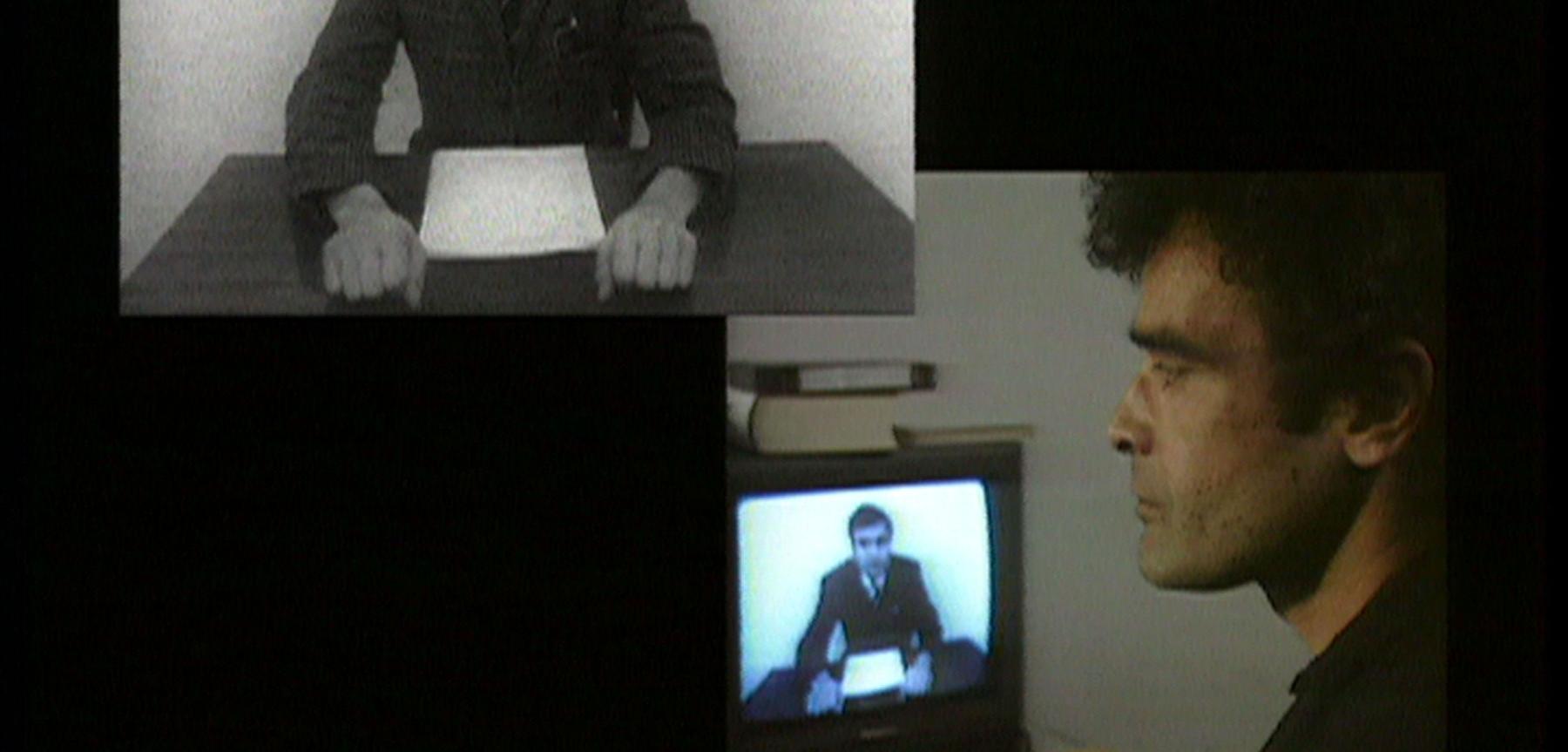 Still from a film showing two different men sitting at desks collaged together