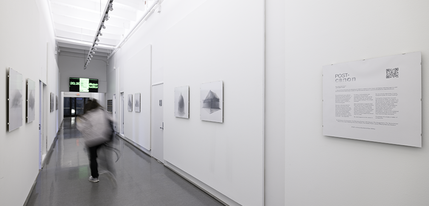 Photo of the hallway exhibition with black and white images hung on white walls.