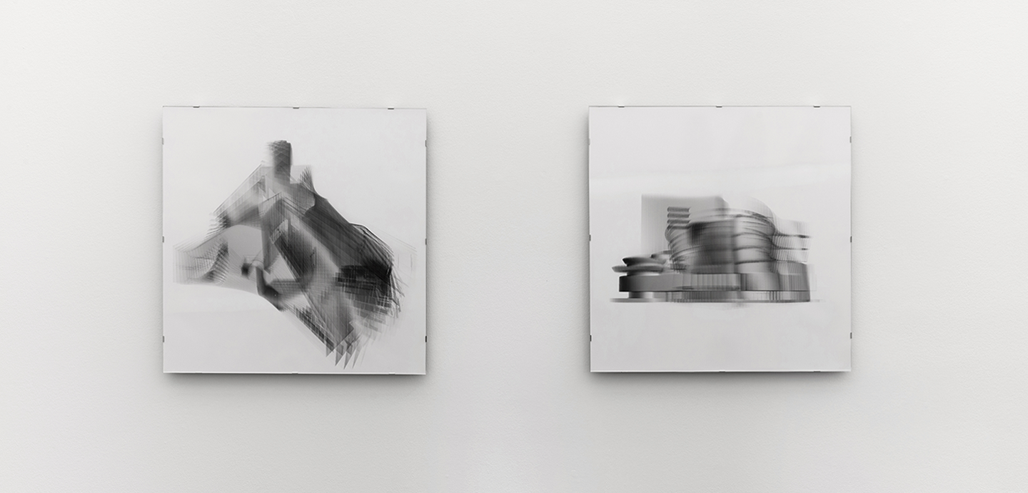 Two square, black and white architectural images hung on a white wall.