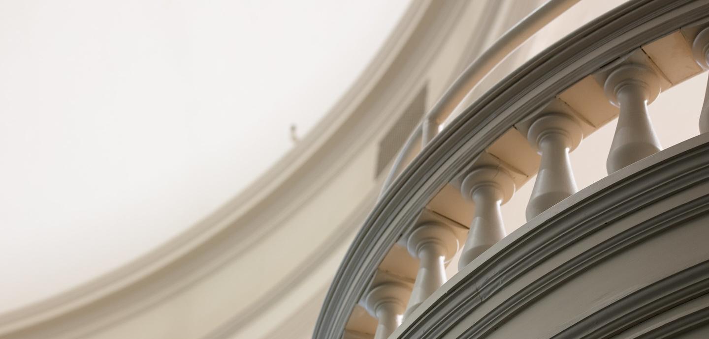 a white banister with light filtering through