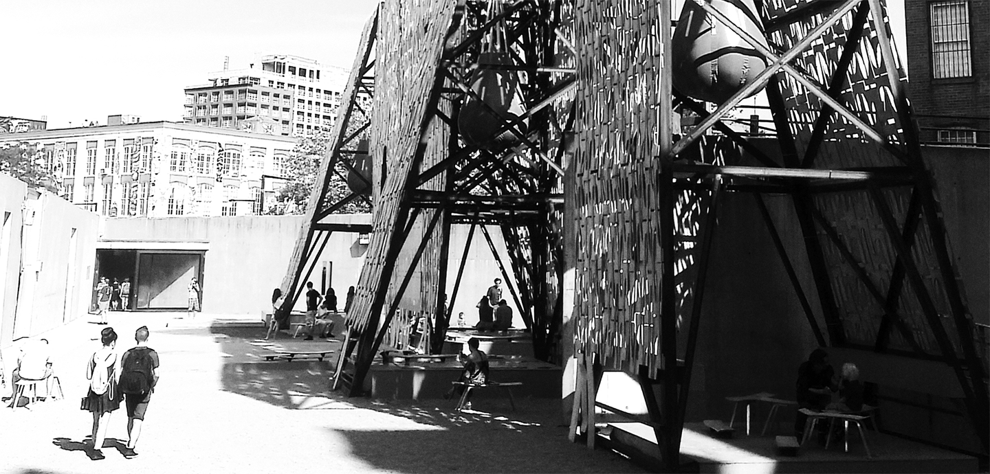 steel structure with 2 passersby with background of old city buildings
