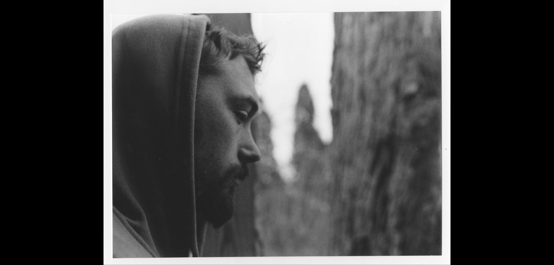 black and white photograph profile of a person in a hoodie