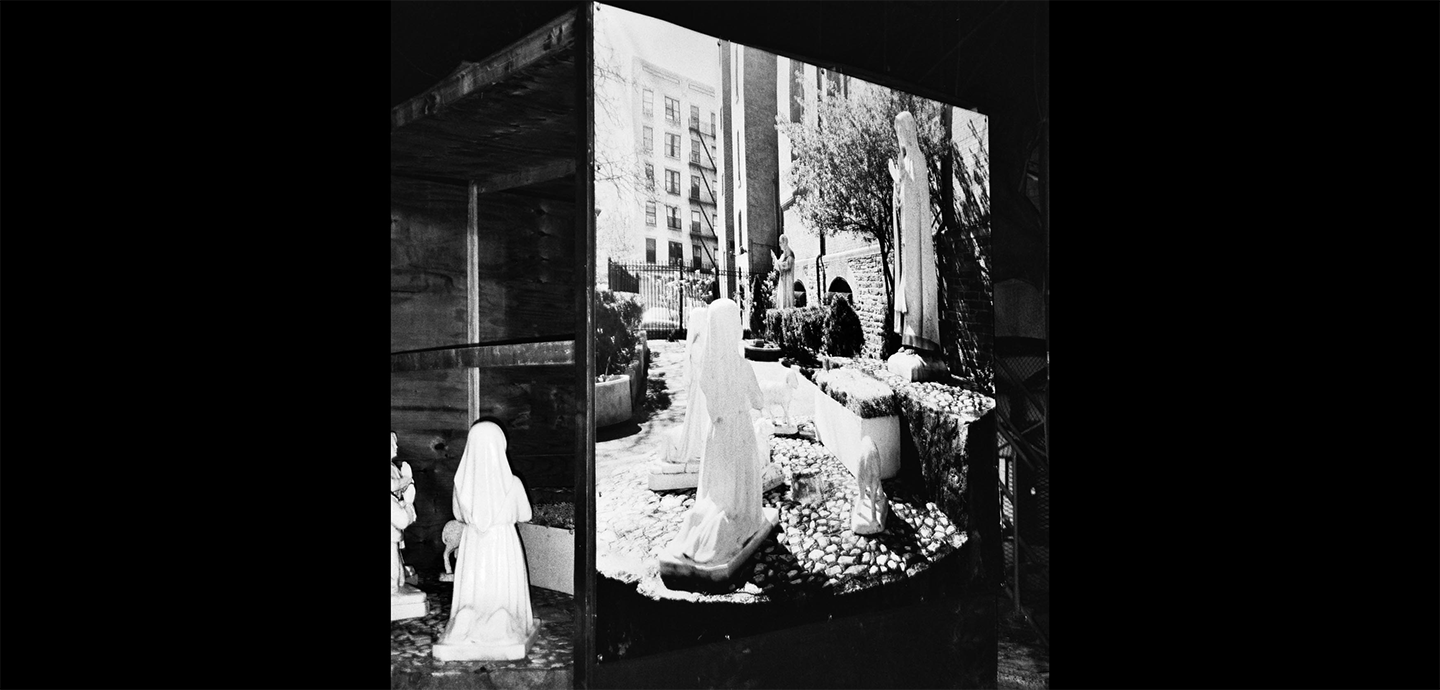 Black and white image of kneeling woman white veil