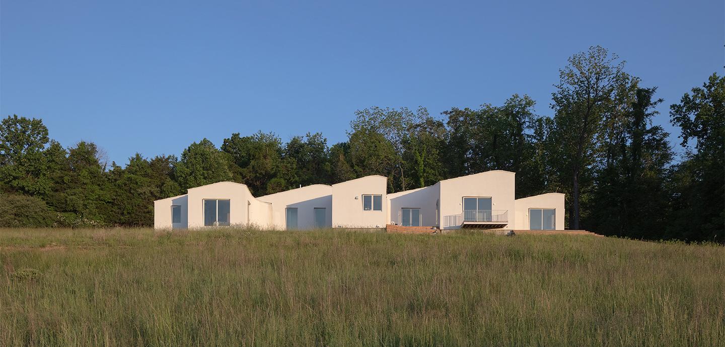 Simple white cubical houses in a bright field