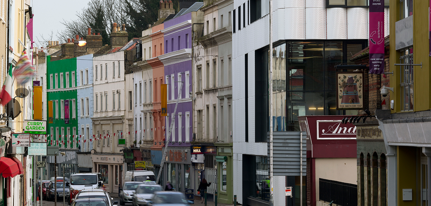 Busy urban street filled with cars and colorful buildings