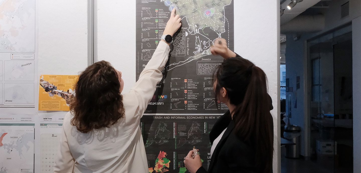 Students viewing pinned work in studio 