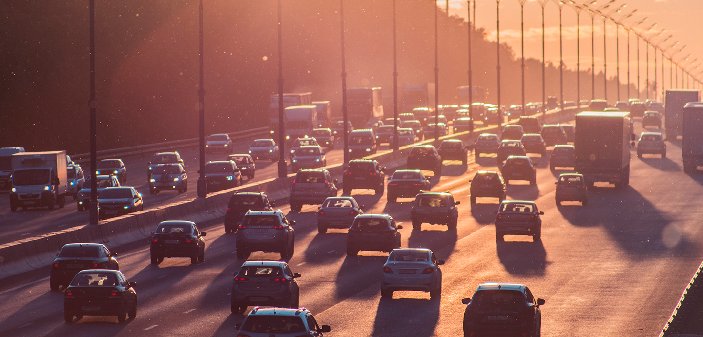 photo of highway traffic with sunset