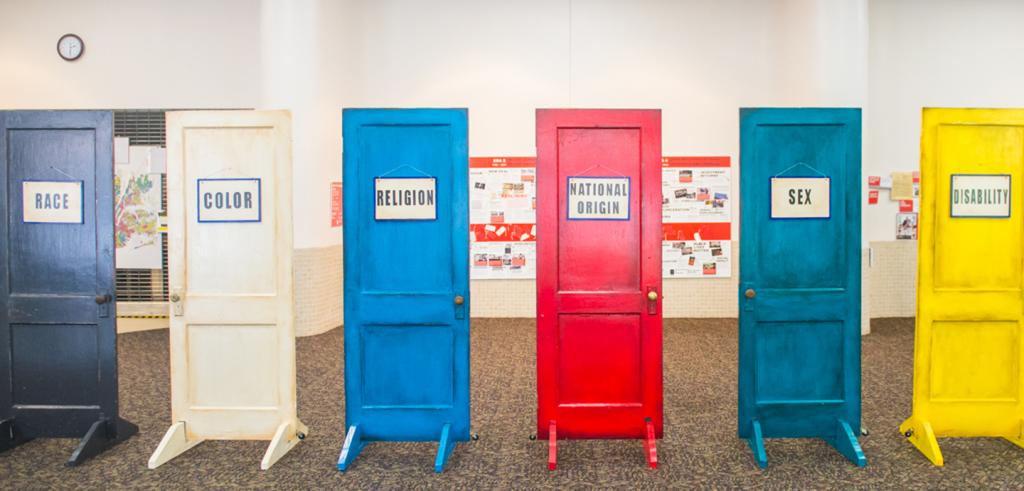 doors painted different colors, each with a different sign, reading 