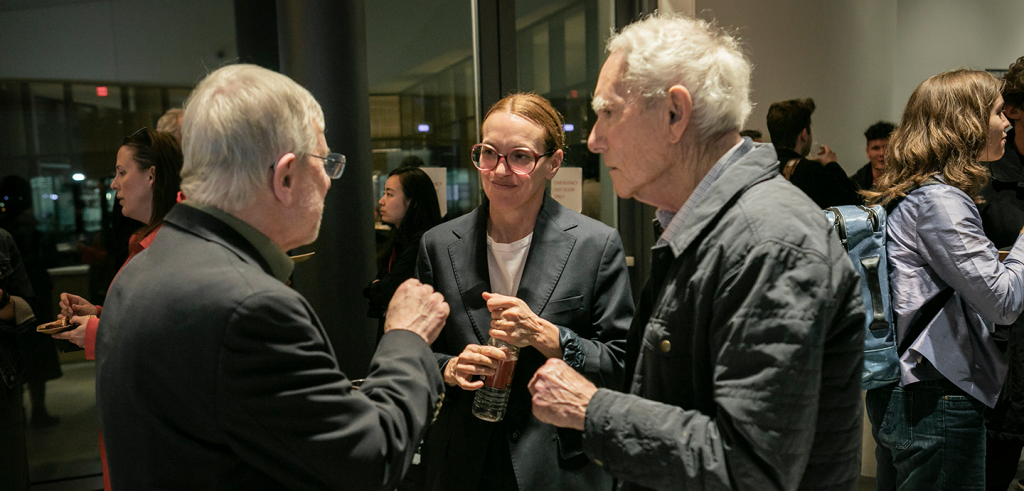 a small group of people speaking to each other