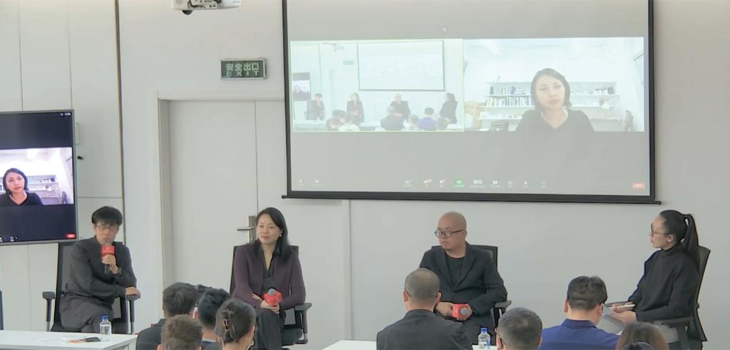 Panelists speaking with a projected screen behind them.