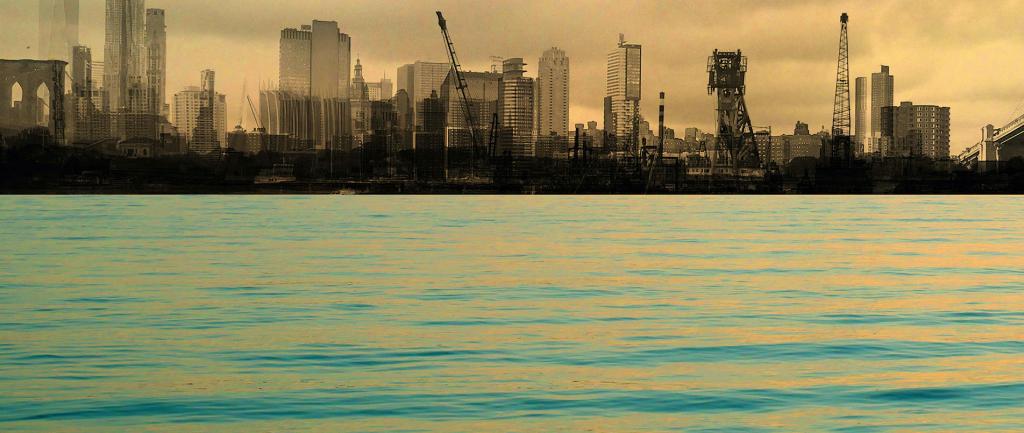 a large body of water with a city skyline in the background.