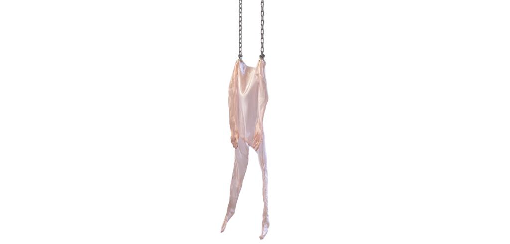 Color photo of a skin suit sculpture made from shiny pale pink fabric, hanging from thick chains on a white background. 