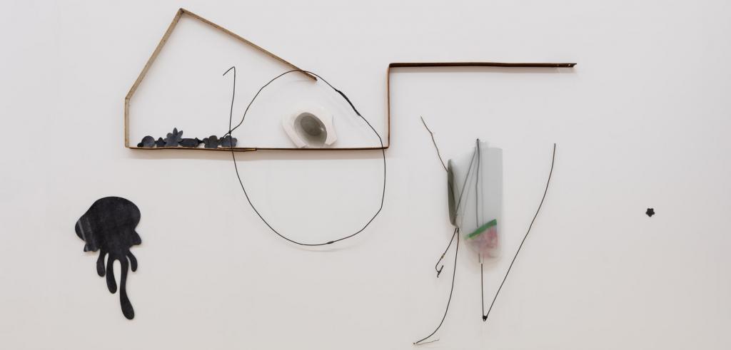 Abstract art pieces made of acrylic, wire, and wire on a white wall.