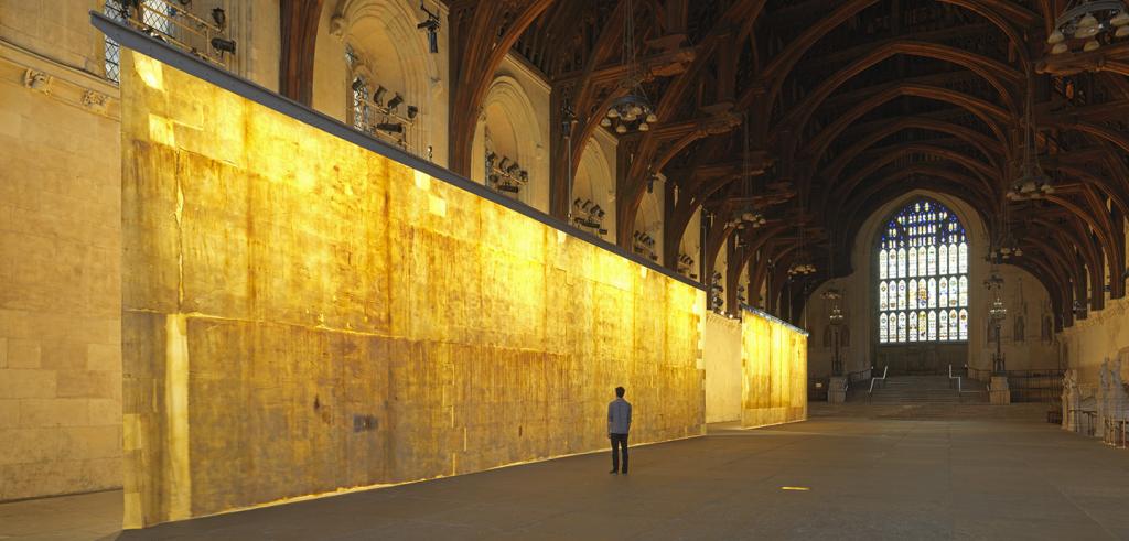A large, yellow panel hanging in a long arched hall