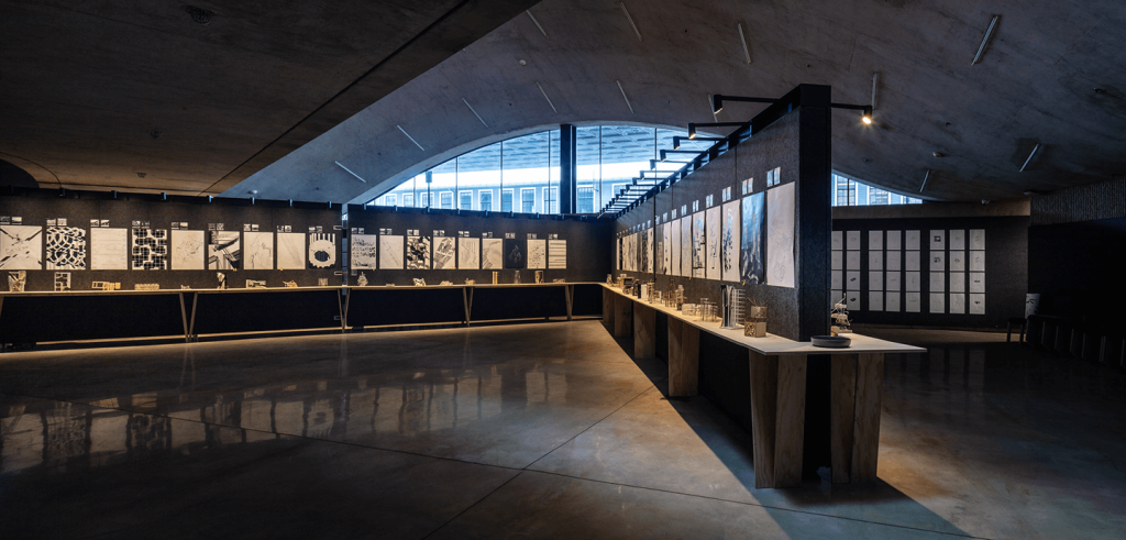 An empty gallery with artwork on the walls.