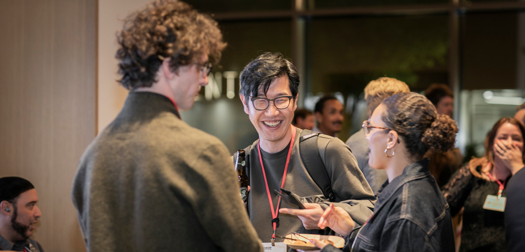 a group of people talking and laughing