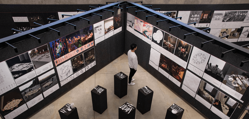 A person viewing artwork in a gallery.