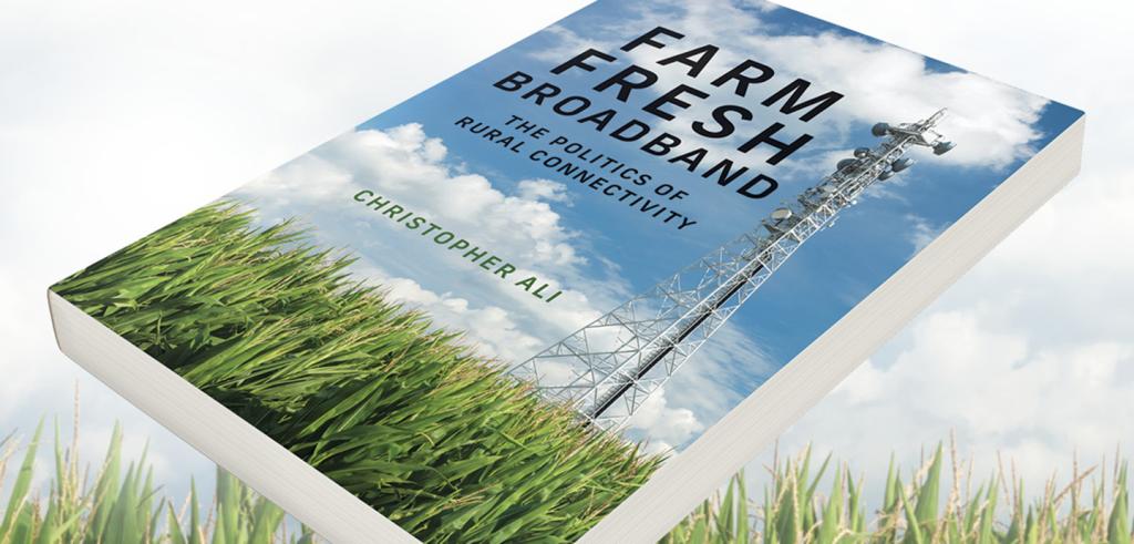Book with an outdoor scene with green grass, a tower, blue sky and clouds. The title on the book states 