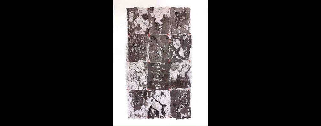 12 rectangles of light grey, dark grey, white, and red paper sit together to form a larger rectangle. The pieces of paper are decorated with abstract designs. 