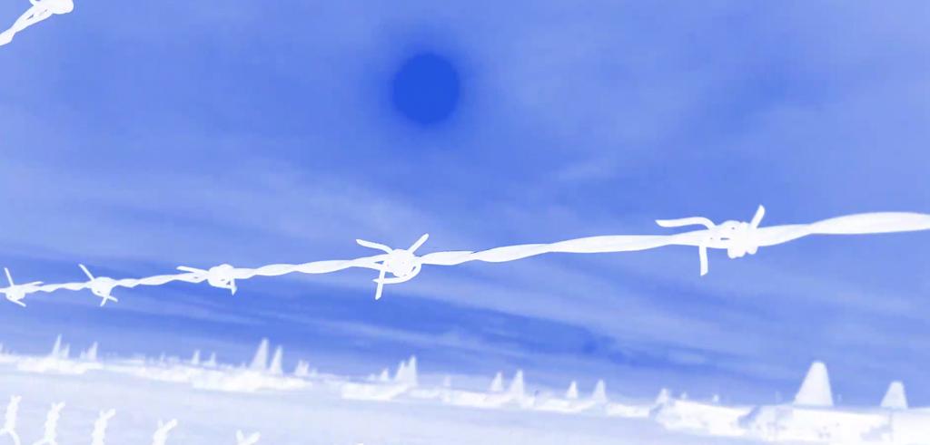 Bright blue sky with white faded clouds behind bright white wired fence.