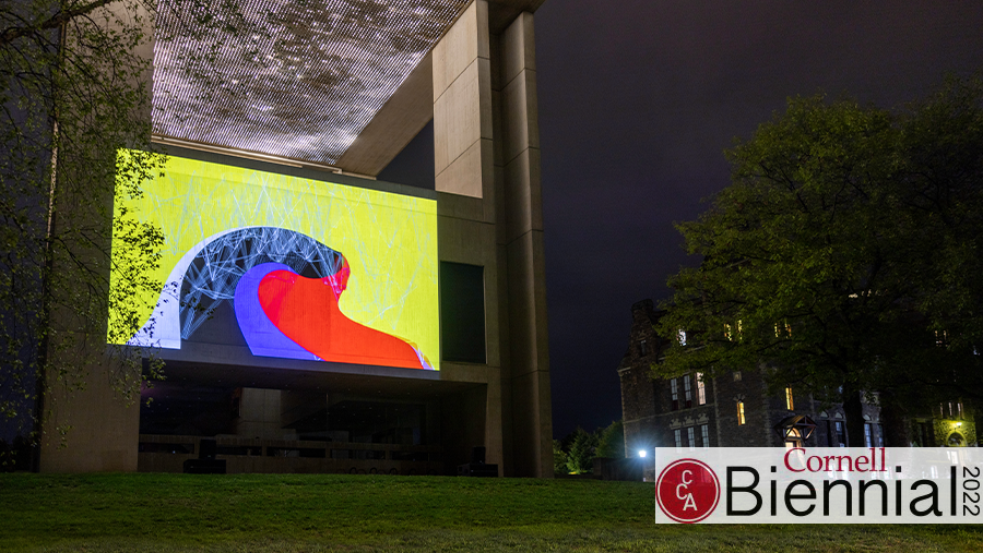A large screen projection on the side of a museum building.
