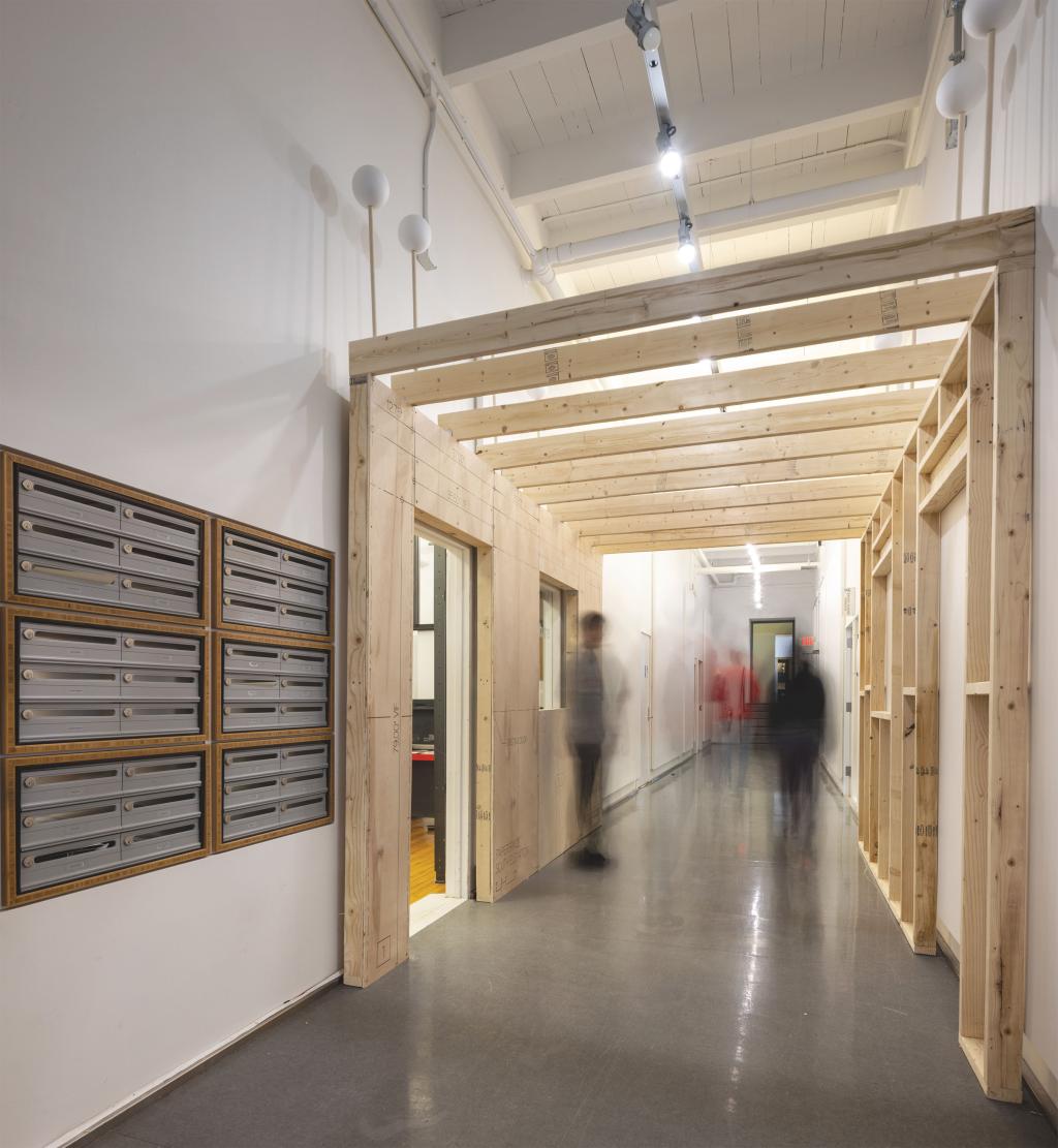 A hallway with blurry people walking through a wooden archway