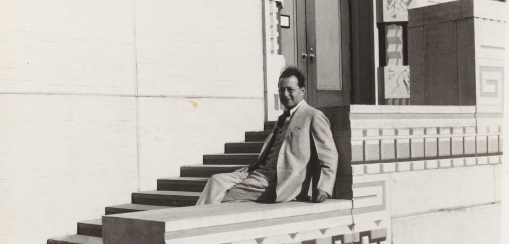 man seated on steps of a building