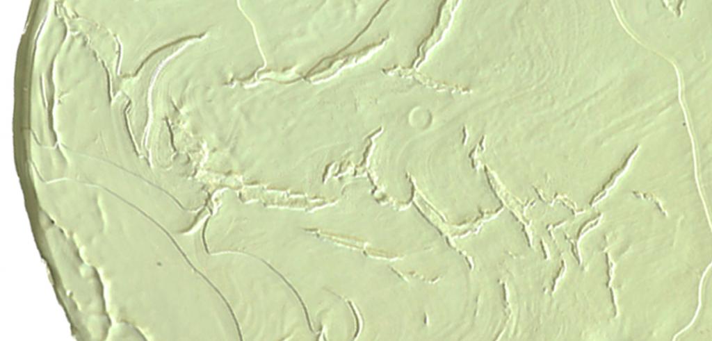 Closeup of a yellow spot on a painting.