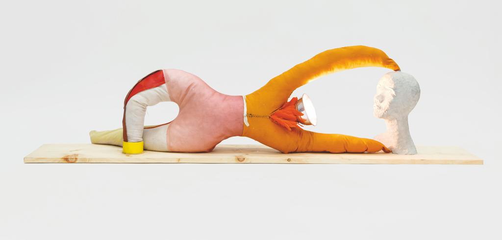 A pink and orange fabric sculpture with two claw-like extensions connected to a bust of a person.