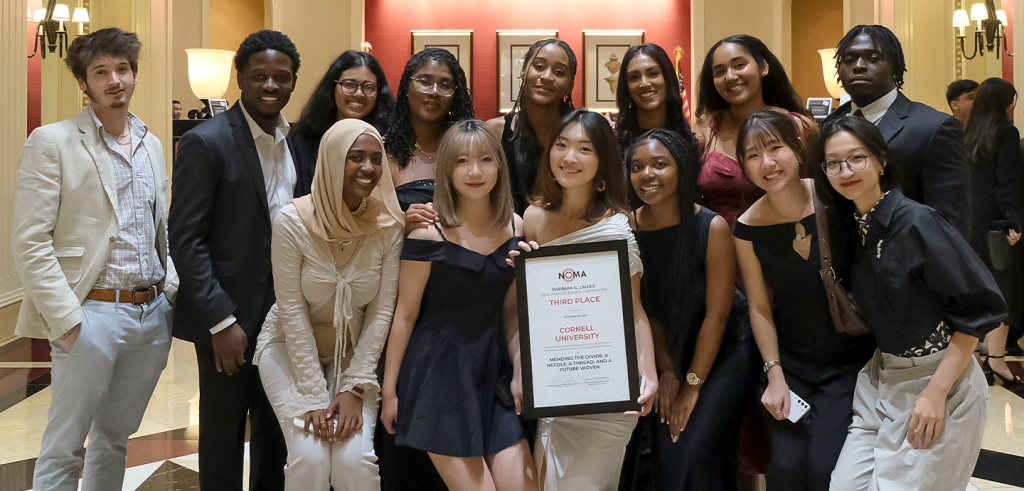 A group photo of 14 students dressed formally.