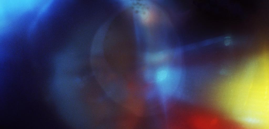 Abstract photograph of navy, red, and yellow lights. 