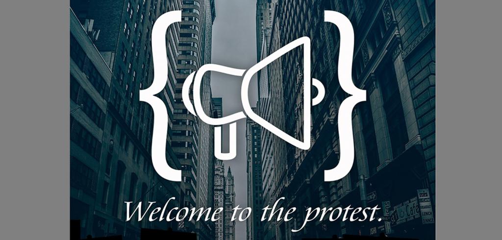 View down a city street with buildings on both sides with a white printed image of two brackets and a megaphone with white text welcome to the protest.