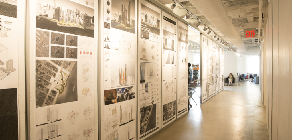A hallway corridor with architecture posters on the wall.