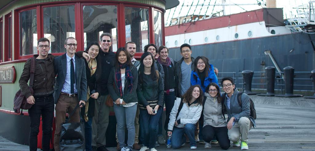 Bob Balder with students posing in front of a water taxi