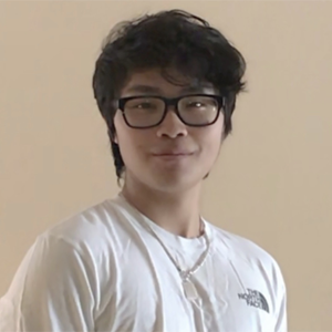 student with black hair and black glasses, white shirt