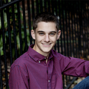 student with short brown hair and purple button down shirt