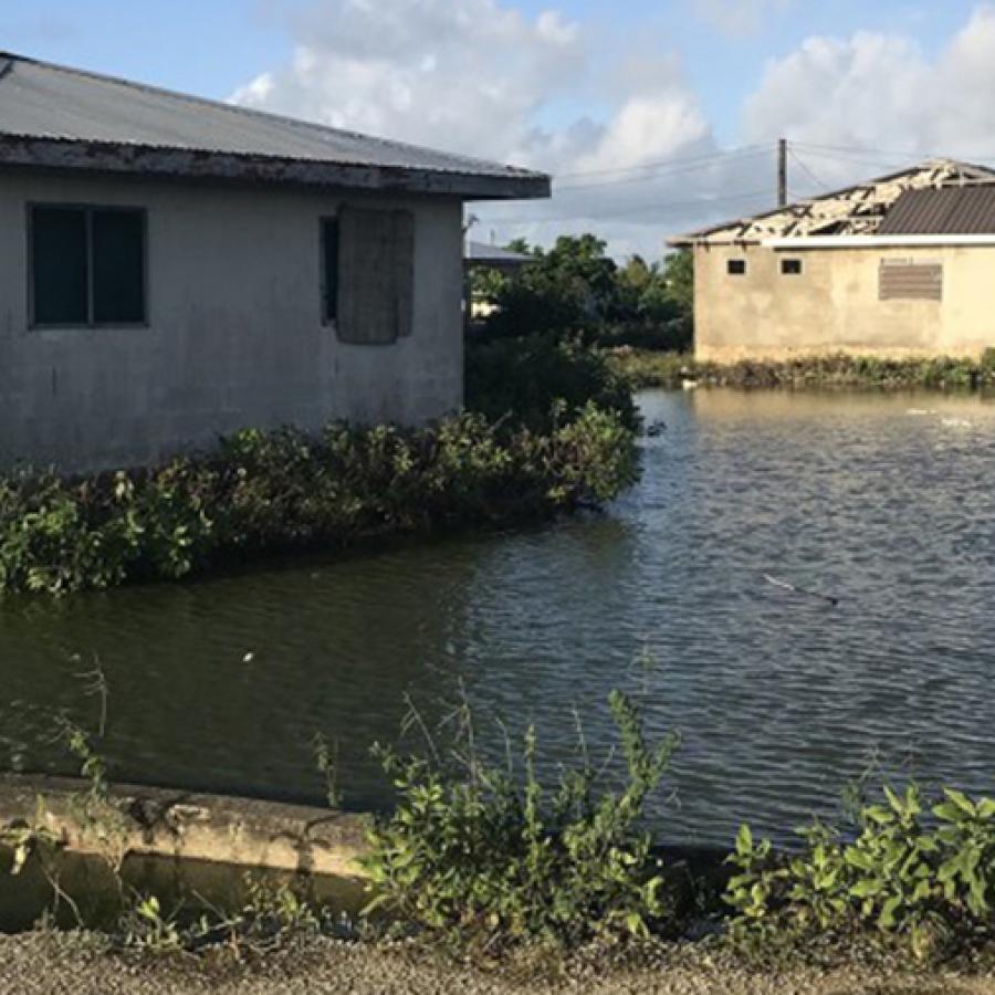 water level at the base of boarded-up buildings