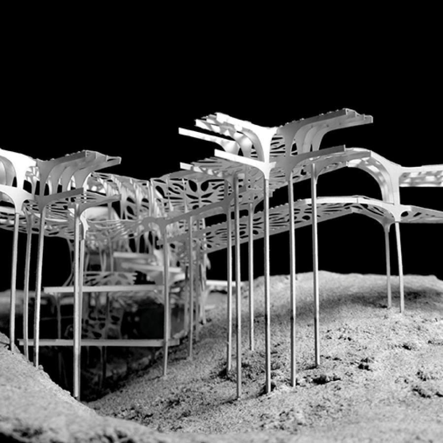 Porous paper model sits on columns in mountain with black background.