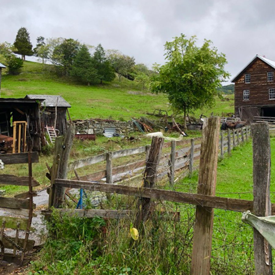 farm building in hark wood and green hills