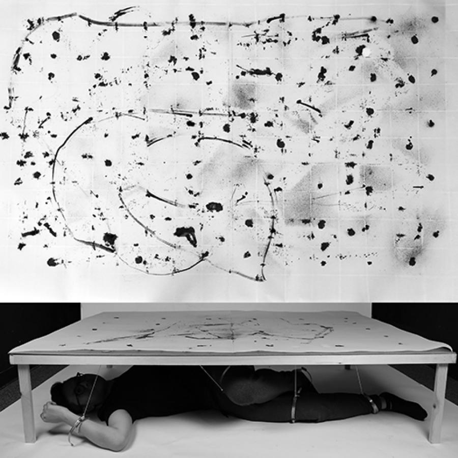 Photograph of a person using a drawing machine. 