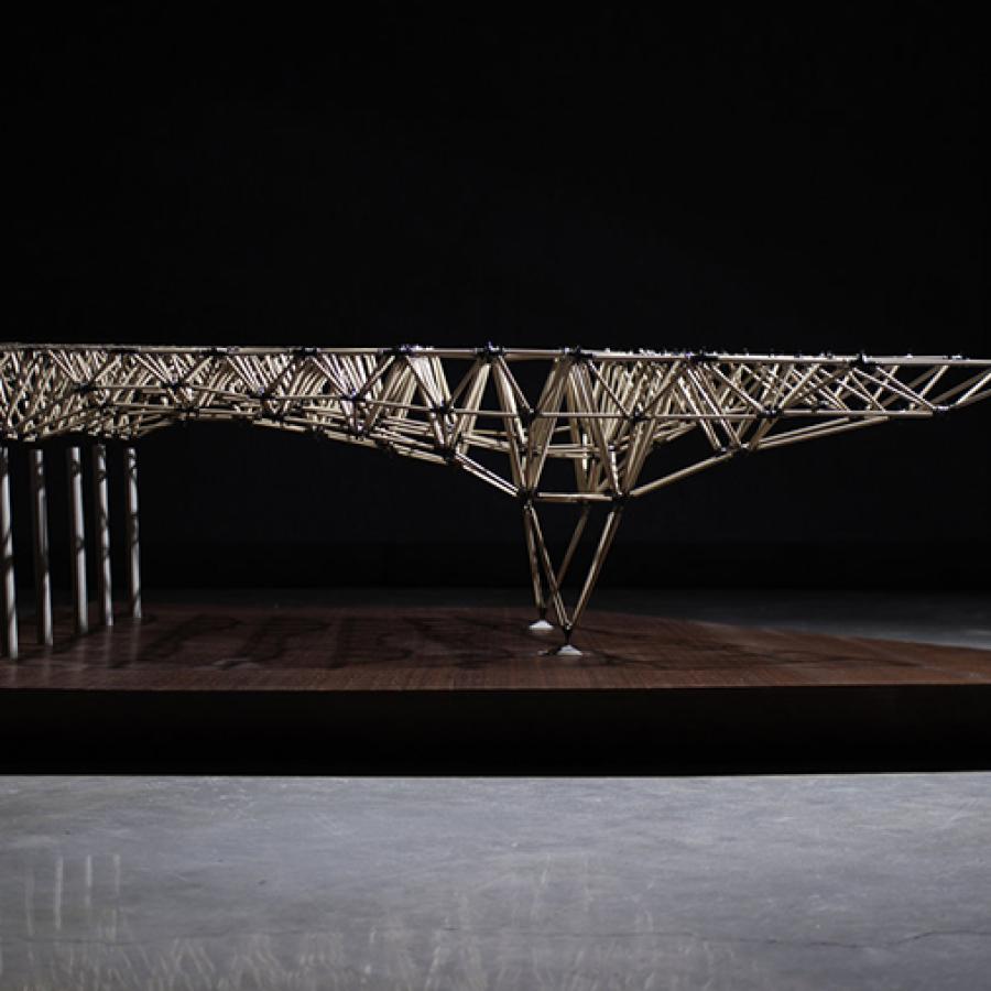 Architectural model constructed out of wood and elevated on a platform. 