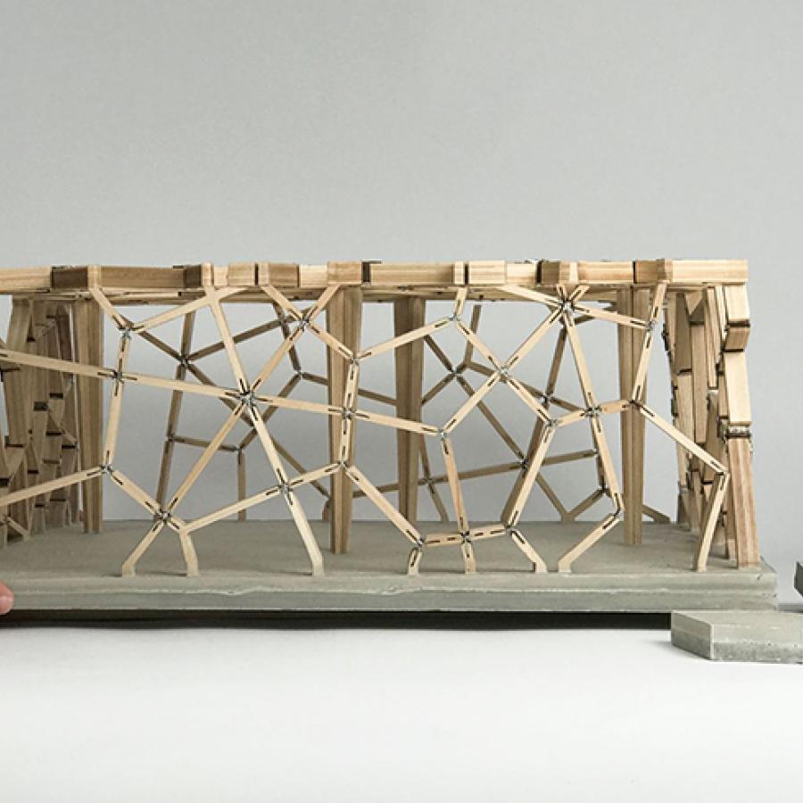 Architectural model constructed out of wood and elevated on a platform. 