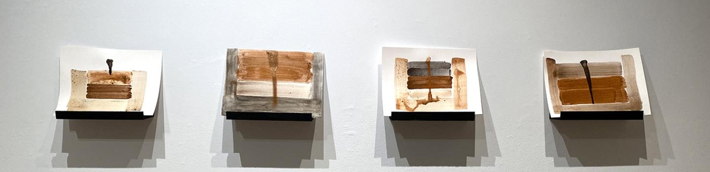 Four water color images in various shades of brown, black and cream with shadows beneath them. 