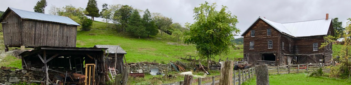 picture of farm building in hark wood and green hills